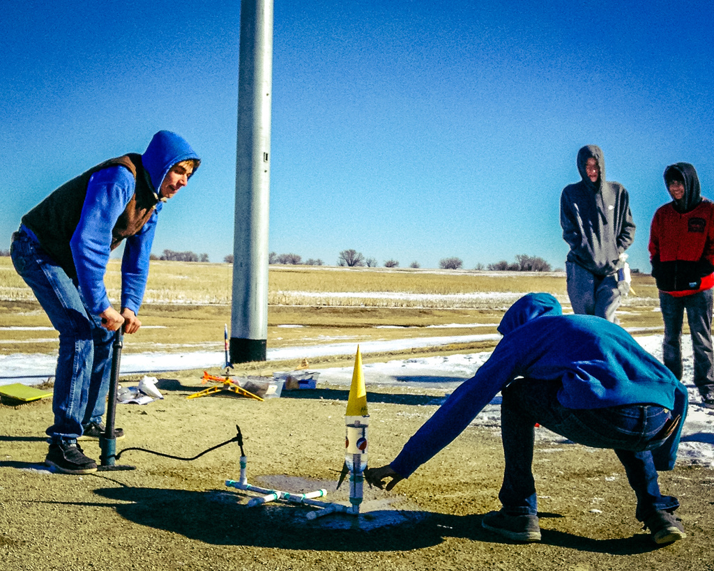 HS STEAM has been examining Newton's Laws in regards to rocketry and launched the first of their constructed rockets, water bottle rockets, today.  Water bottle rockets utilize pressurized water as their propellent, and can launch as high as  400 feet.  Students used a homemade altimeter to track their rockets, and using the tangent of the angle on the altimeter, calculate how high their rocket launched.  Our rockets were able to fly around 250 feet high.